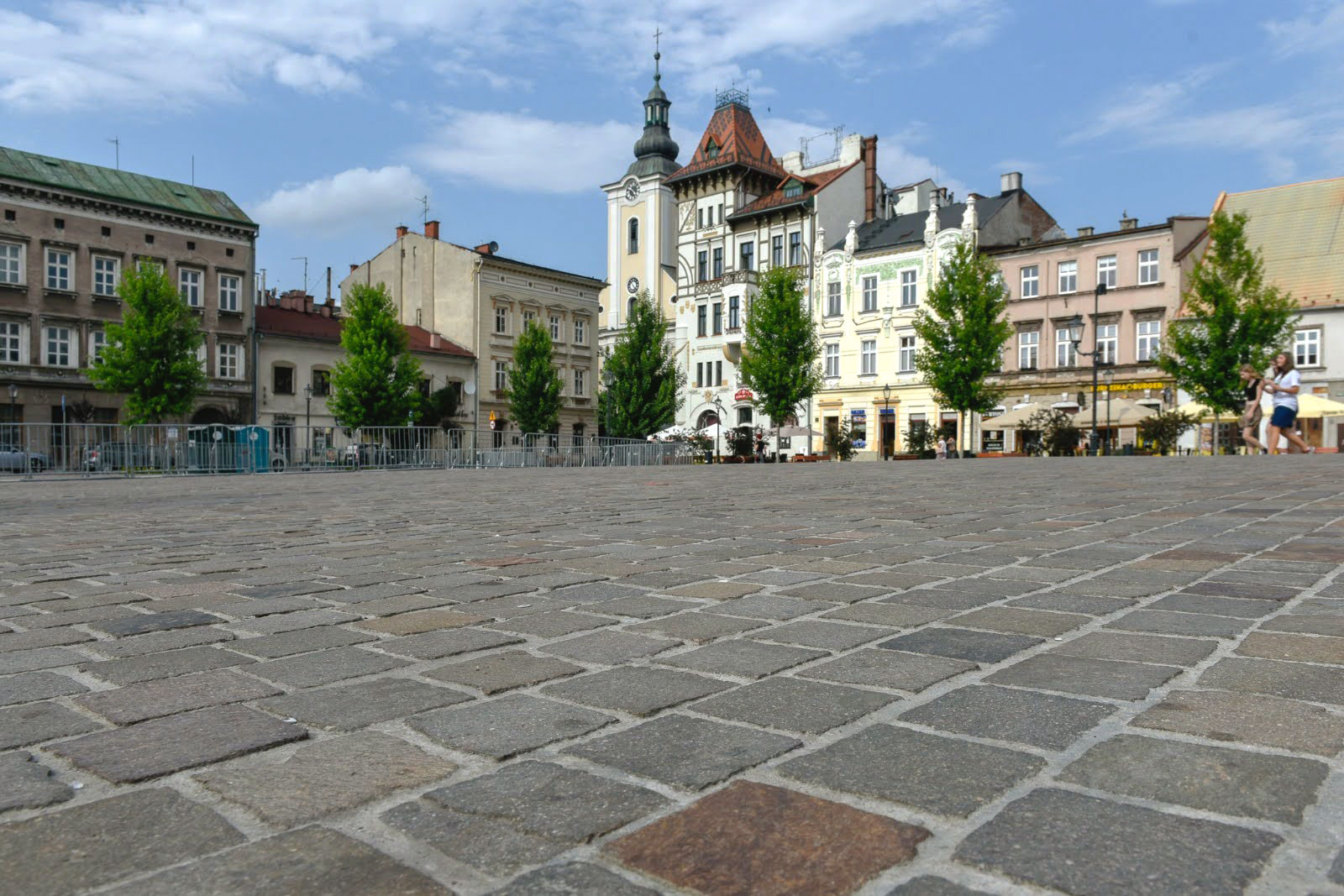 Close view of porphyry paving with a town square in the background